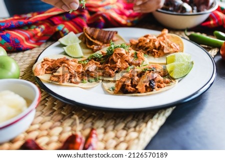 mexican street tacos al pastor with lemon, sauce, onion and cilantro in Mexico city