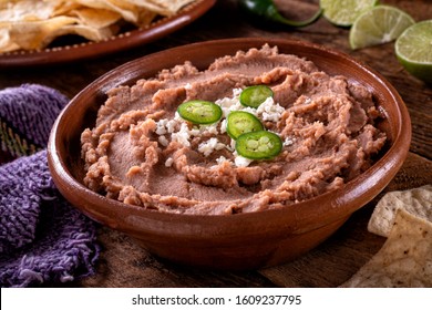 Mexican style refried beans with queso fresco and jalpeno pepper garnish.