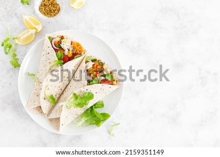 Mexican tacos with chicken meat and vegetables. Top view