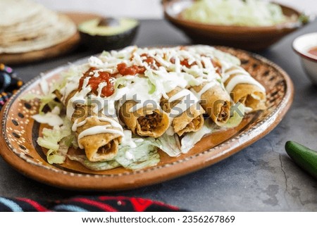 Mexican tacos dorados called flautas with chicken, traditional fried food in Mexico Latin America	
