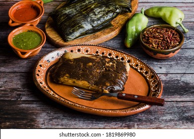Mexican Tamales Oaxaquenos in banana leaves traditional from Oaxaca Mexico on wooden background