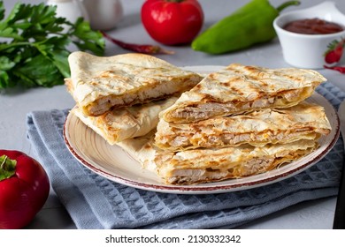 Mexican Tortilla Quesadilla With Turkey, Cheese And Tomato Salsa On Gray Background