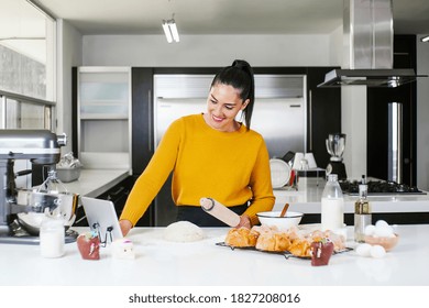 Mexican woman baking Pan de Muerto traditional bread from Mexico in Halloween - Powered by Shutterstock