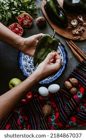 Mexican Woman Cooking Chiles En Nogada Recipe With Poblano Chili And Ingredients, Traditional Dish In Mexico