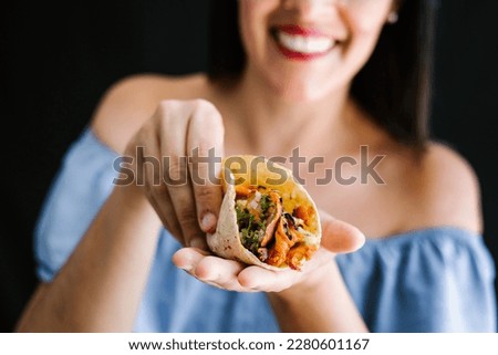 Mexican woman eating tacos al pastor, mexican food in Mexico Latin America	