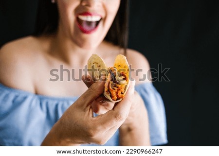 Mexican woman eating tacos al pastor, mexican food in Mexico Latin America	
