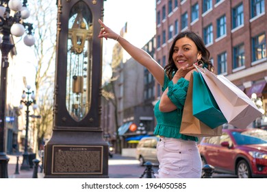 Mexican Woman Enjoying Shopping In Downtown Canada And Pointing To Her Next Destination