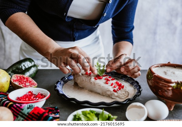 mexican woman hands preparing and cooking chiles\
en nogada recipe with Poblano chili and ingredients, traditional\
dish in Mexico