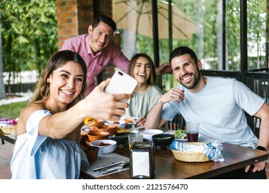 Mexican Woman Taking A Photo Selfie With Group Of Latin Friends And Eating Mexican Food In Restaurant Terrace In Mexico Latin America