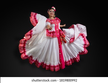 
Mexican woman with traditional folk costume from Colima, white dress with Mexican pink ornaments, Colima hat, Latin Mexican dancer with traditional costume from the state of Colima Mexico