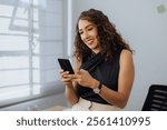 Mexican woman using phone in office