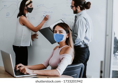 Mexican Woman Working In Office Or Coworking While Wearing Medical Face Mask For Social Distancing In New Normal Situation Protecting The Infection Of Corona Virus Or Covid-19 Latin America Mexico