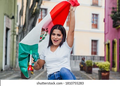 Mexican young girl holding a flag of mexico