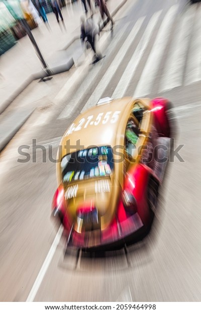 Mexico city, Mexico - April 26 2010 : a\
beetle taxi cab on full motion and speed on the\
road