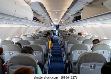Mexico City, Mexico, August 2., 2019, International airport Benito Juarez, interior of commercial interjet plane before takeoff rows of grey seats and empty aisle, open luggage cabinet and open door