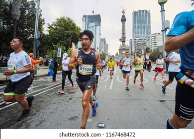 Mexico City, CDMX, Mexico, 08-26-18  36th International Marathon Of Mexico City. Crowd Of Runners At Reforma Avenue With The Angel Of Independence On The Background