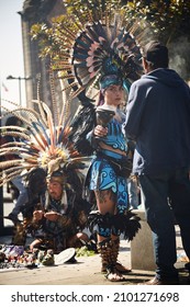 Mexico City, CDMX, Mexico 12-29-2021 Typical Aztec Shaman Woman Called Conchero With A Magnificent Costume And A Plume Or Feather Headdress At The Zocalo On The Street Performing A Spiritual Cleansing