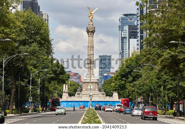 Mexico City, CDMX, Mexico 9-12-2021\
Panoramic view of Reforma avenue with little traffic at the Angel\
of Independence on a beautiful sunny Sunday\
afternoon.
