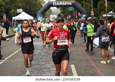 Mexico City, CDMX, Mexico August 28 2022 Telcel Mexico City Marathon 2022, Woman Followed By A Crowd Running Over Reforma Avenue With Supporters On The Side.