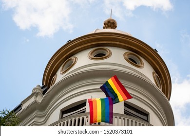 MEXICO CITY, CDMX / MEXICO - June 29, 2019: Man Hoisting The Gay Flag On The Balcony Of A Building On Paseo De La Reforma.