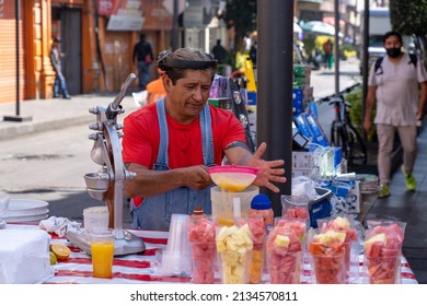 Mexico City, Mexico - February 15 2022: Street vender making juice drinks in Mexico City