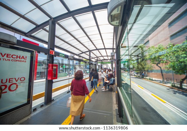 Mexico\
city - June 25, 2018: panoramic view of people walking inside a\
metrobus station in Mexico City on a sunny\
day