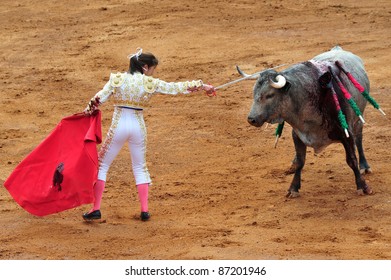 MEXICO CITY - MAR 1 2010:Young Adult Mexican Woman Matador And A Bull In A Standoff Before Engaging In A Bullfight Battle In Plaza De Toros In Mexico City, Mexico.