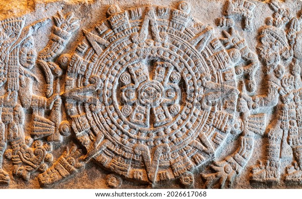 MEXICO CITY, MEXICO - MARCH 22, 2020: Aztec ruler\
Moctezuma II and God of war Huitzilopochtli around the fifth sun in\
a military bas relief.