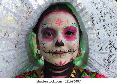 MEXICO CITY - OCT 23: Unknown participant on a Parade of Catrinas in Paseo de la Reforma Avenue, Mexico, on October 23 2016. The Day of the Dead is one of the most popular holidays in Mexico
