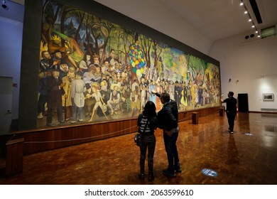 Mexico City, Mexico - October 24, 2021: People Look On The Big Painting 