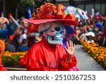 Mexico City, Mexico ; October 31 2021: Day of the dead parade in Mexico city, Catrinas with colorful costumes in an exciting tradition