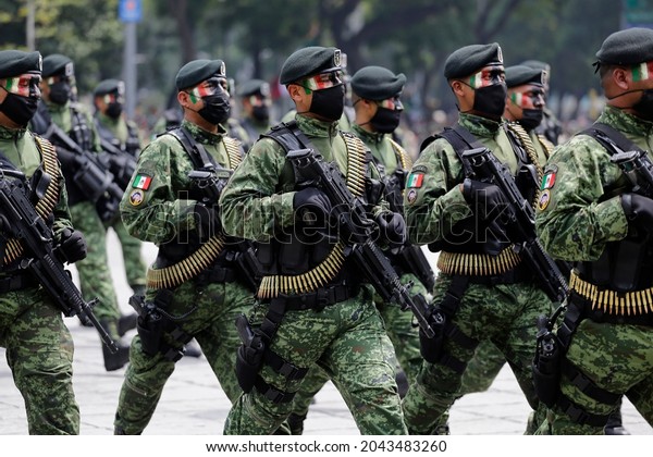 Mexico City, Mexico - September 16, 2021: Army\
soldiers, wearing face masks to protect from COVID-19, parade\
during the Mexico\'s Independence Day celebrations in Paseo de la\
Reforma avenue.