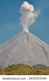Mexico Colima closeup of Active Volcano ejecting steam cloud on bright sunny day in 2015