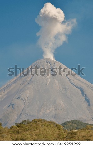 Mexico Colima closeup of Active Volcano ejecting steam cloud on bright sunny day in 2015