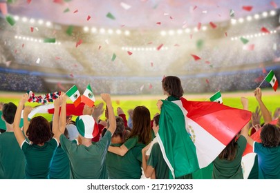 Mexico Football Supporter On Stadium. Mexican Fans On Soccer Pitch Watching Team Play. Group Of Supporters With Flag And National Jersey Cheering For Mexico. Championship Game. 