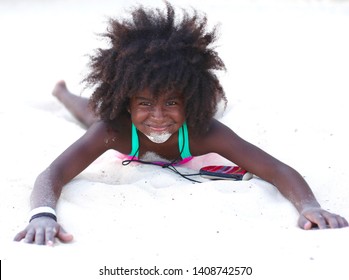 Mexico, North America. United States Of America. 21st October 2018. The Grand Hyatt Hotel. A Young Black Child, Playing On The Beach In The Sand. Sand On Her Chin. On A Very Hot Day.