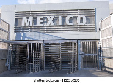 Mexico sign and turnstile revolving gates at pedestrian border crossing from San Ysidro, United States to Tijuana, Mexico early in morning with no people