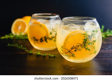 Meyer Lemon and Thyme Bees Knees Cocktails: Gin cocktails made with Meyer lemon juice and garnished with thyme sprigs and a slice of lemon