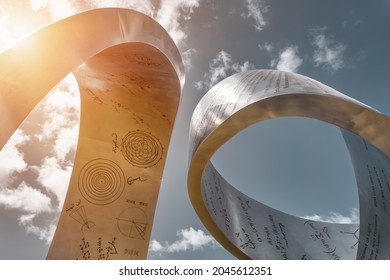MEYRIN, CANTON OF GENEVA, SWITZERLAND - AUGUST 31, 2021: Steel sculpture "Wandering the immeasurable" by artist Gayle Hermick at CERN. Shaped like a ribbon, it honors great discoveries in physics.