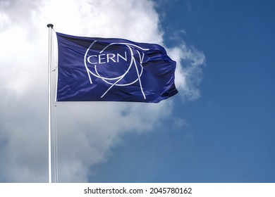 MEYRIN, CANTON OF GENEVA, SWITZERLAND - AUGUST 31, 2021: Flag of CERN. Logo, symbol of the European Organization for Nuclear Research, operating the largest particle physics laboratory in the world. 