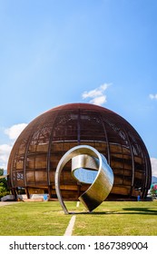 Meyrin, Switzerland - September 7, 2020: The steel ribbon titled "Wandering the Immeasurable" by Gayle Hermick and the Globe of Science and Innovation at CERN, the European Center for Nuclear Research