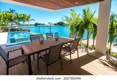 Miami Beach - April 2019: View Of Patio Deck With View Of Infinity Pool And Bay. Daytime Shot Of Luxury Home.