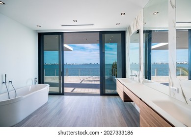 Miami Beach - April 2020: A spacious bathroom with view of outside bay. Daytime shot of luxury home.