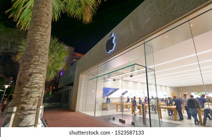 MIAMI BEACH - FEBRUARY 25, 2016: Tourists walk visit Apple Store at night time. Apple is a major technology company based in California.