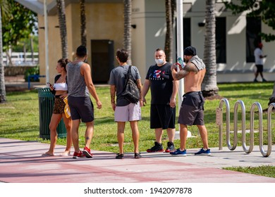 MIAMI BEACH, FL, USA - MARCH 20, 2021: Young People In Miami Beach Visiting For Spring Break During Coronavirus Covid 19 Pandemic