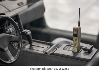 MIAMI BEACH, FL, USA - NOVEMBER 10, 2019: Old Antique Cellular Phone In An Old Car