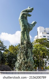 MIAMI BEACH, FL, USA - OCTOBER 14, 2019: The Holocaust Memorial In Miami Beach Features A Reflection Pool With A Hand Reaching Up And Bodies Climbing,  A Memorial Wall, And Memorial Bridge.