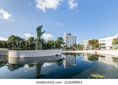 MIAMI BEACH, FL, USA - OCTOBER 14, 2019: The Holocaust Memorial In Miami Beach Features A Reflection Pool With A Hand Reaching Up And Bodies Climbing,  A Memorial Wall, And Memorial Bridge.