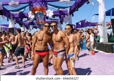 MIAMI BEACH, FLORIDA, MARCH 6, 2016: Winter Party Festival, Ocean Drive In Miami Beach, LGBTQ Gay Beach Party, Group Of Gay Men In Swimwear 