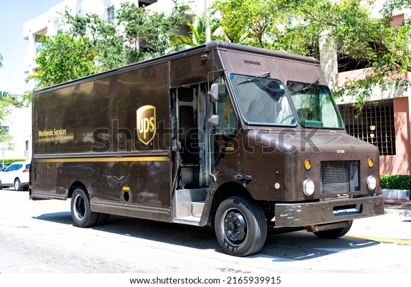 Miami Beach, Florida USA - April\
14, 2021: united parcel service, corner view. brown postal\
truck